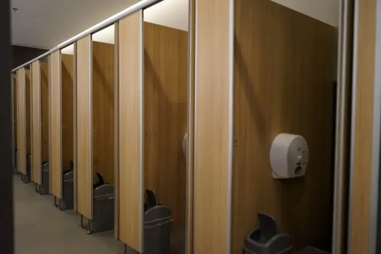 Malfunctioning toilet paper dispenser in the women’s restroom